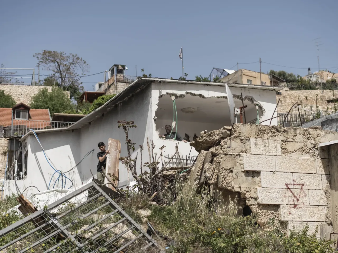 Israel's trying to expel a whole Palestinian district in East Jerusalem, activists say 5 Omar Abu Rajab, 60, and his 14-year-old nephew work on the demolition of their house following the order of the Jerusalem Municipality, in the annexed East Jerusalem district of Silwan.