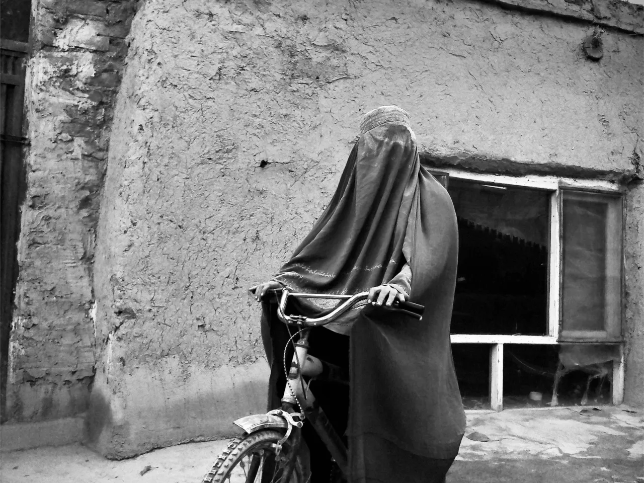Mind-bending photos by anonymous cousins show the pain and dreams of Afghan women 1 This photo of a woman wearing a burka while riding a bicycle is titled "It will not stand in my way."