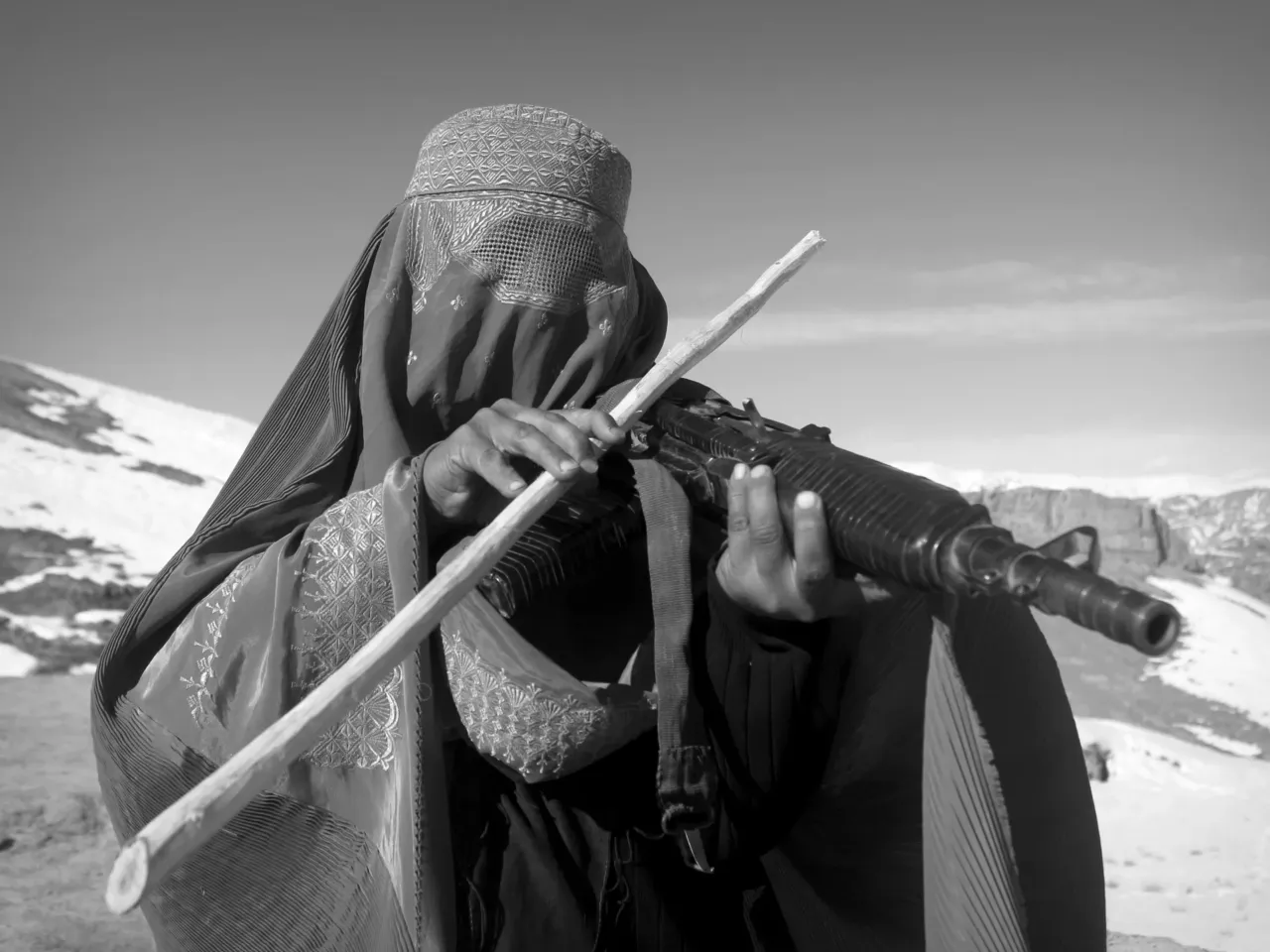 This photo, from a series of pictures by two anonymous cousins, is entitled "The Music of Poverty and Violence." The subject is playing an automatic weapon as if it were a string instrument.