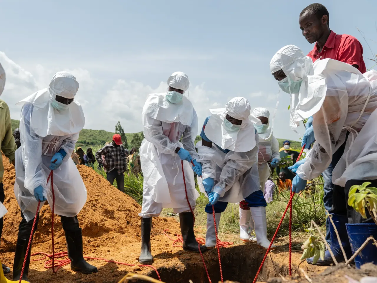 Red Cross workers bury an Ebola victim at the Rwampara Cemetery, in Rwampara, Congo, May 23, 2026.