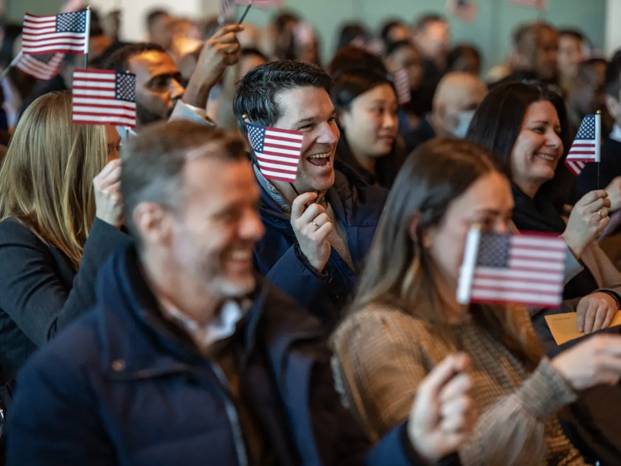 Trump vowed to revoke hundreds of citizenships. It's proving harder to do 1 People wave U.S. flags to celebrate becoming U.S. citizens after taking the oath of allegiance during a naturalization ceremony in the jury assembly room at the John Joseph Moakley United States Courthouse in Boston, Mass., in January 2025.