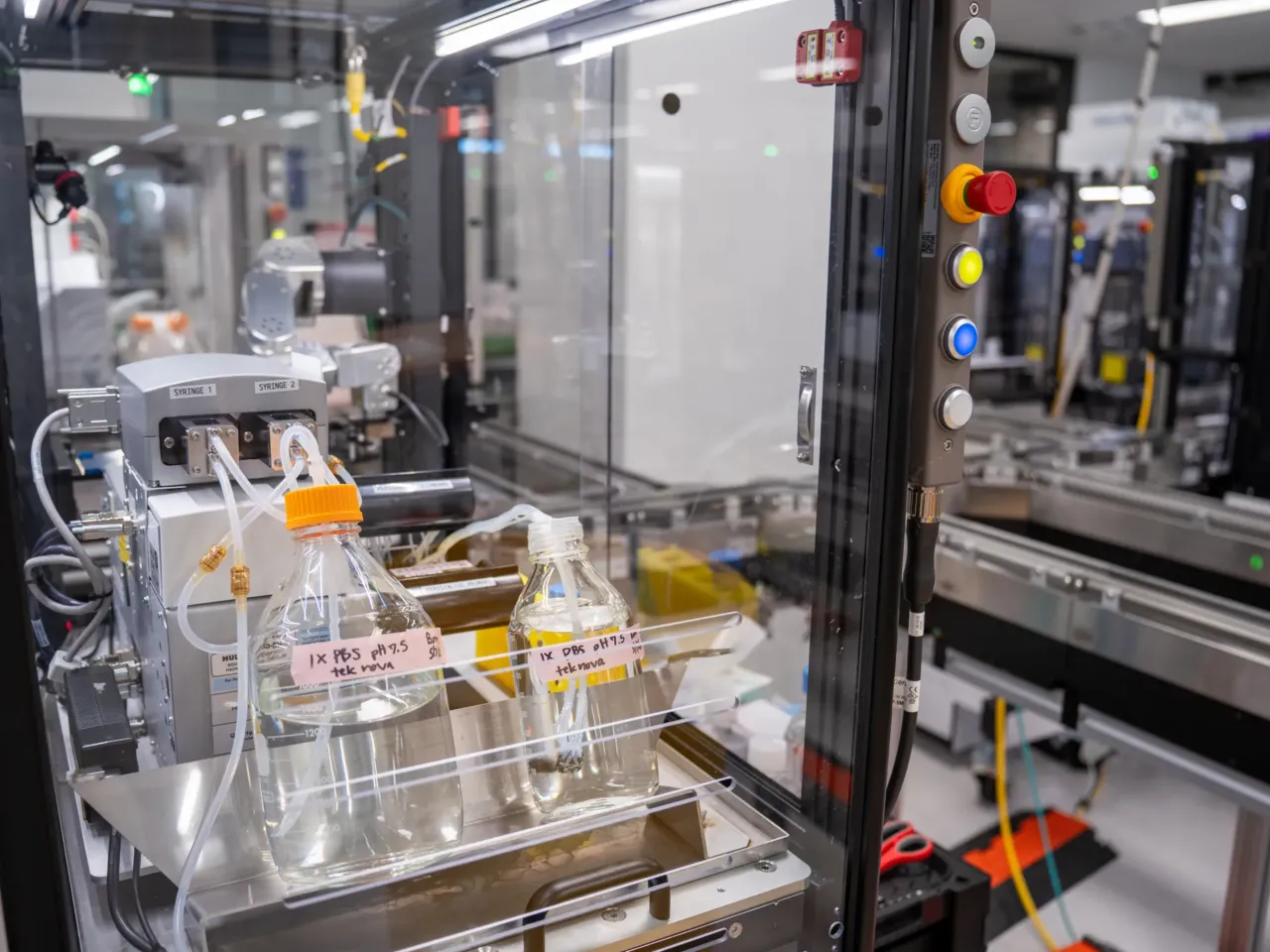 Most of the robots in this lab do not resemble humans, and they perform their work while encased in glass.