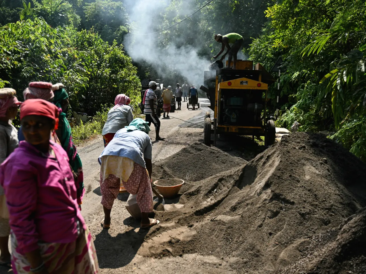 It's one of the world's most isolated islands. Here come the bulldozers 2 In a photograph from March 26, 2026, construction workers operating a tarmac mixer to build a road cutting through the island's forest land.