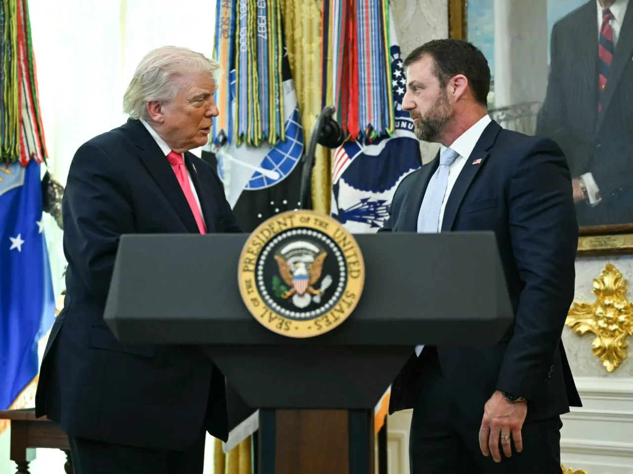 President Trump shakes hands with the newly sworn in Secretary of Homeland Security Markwayne Mullin in the Oval Office on March 24, 2026. Mullin has dialed back some of the aggressive enforcement operations that drew the national spotlight.