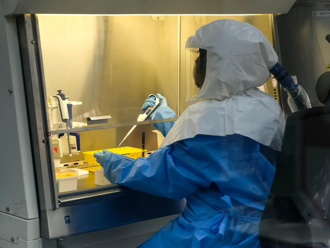 Sophia Mulei, a laboratory technologist, works with a control sample inside the Viral Hemorrhagic Fever Laboratory at Uganda Virus Research Institute in Entebbe, Uganda. The lab is one of the primary centers for the testing of Ebola samples.
