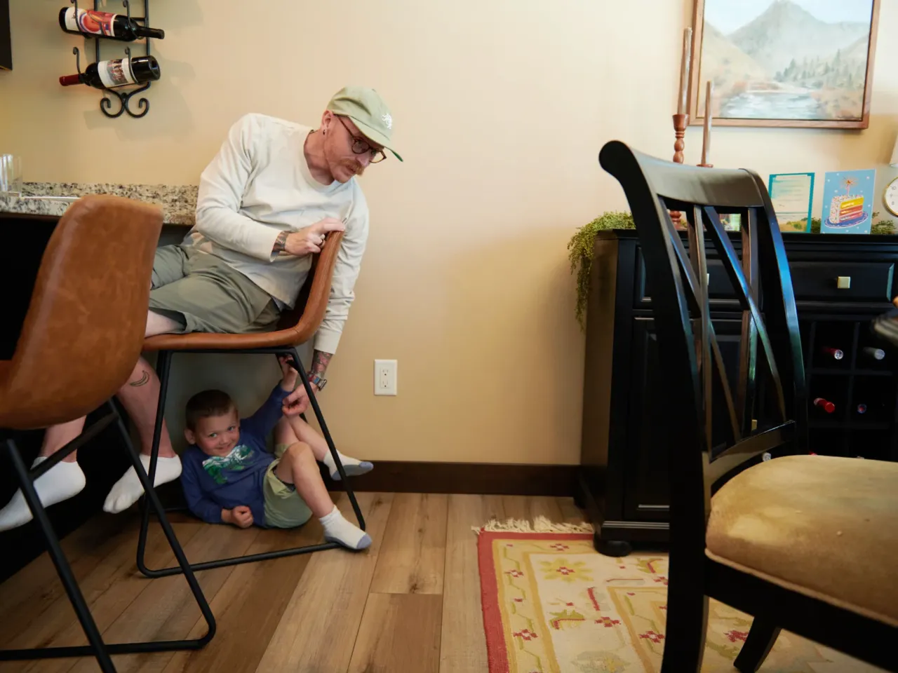 More people are juggling work and kids. Many are finding they can't give 100% to both 2 Neil Petersen plays with his 4-year-old son, Jack. Neil works in a factory painting boom trucks.