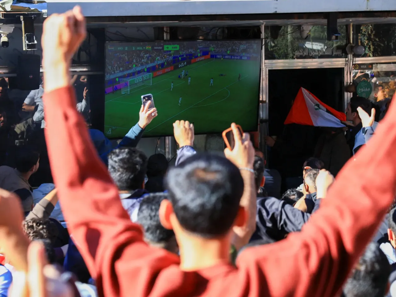Iraqis gather on the streets to watch Iraq play against Bolivia during the FIFA World Cup inter-confederation playoff, in Baghdad, Iraq, April 1, 2026.