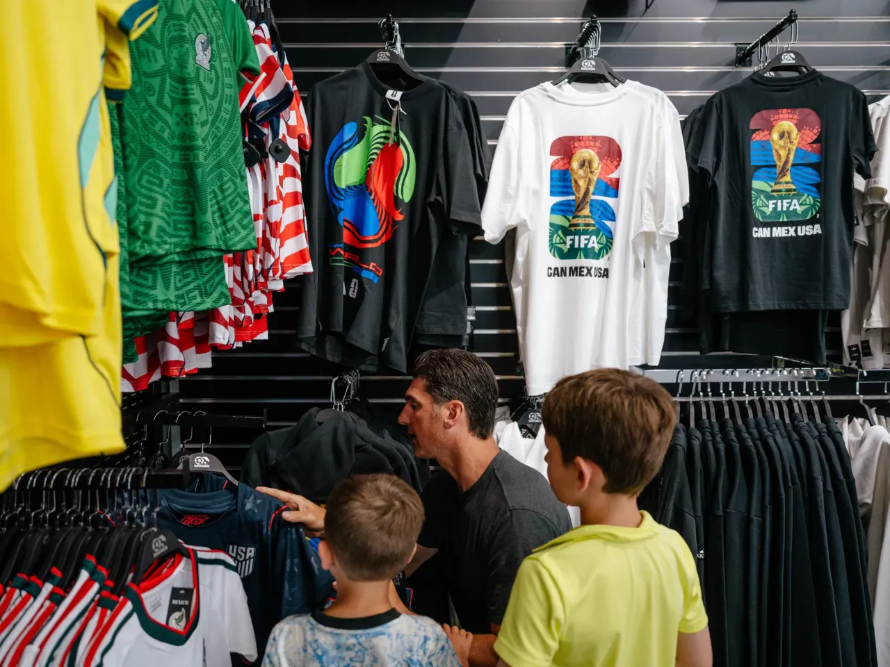 Shopper Matt Abro looks at U.S. Men's National Team jerseys with his sons at Soccer World.