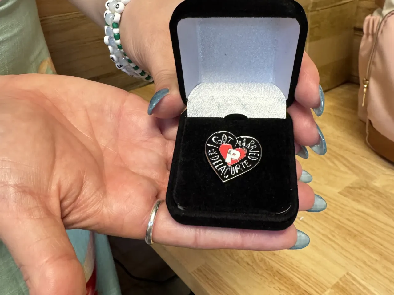 This couple got married at the end of Romeo and Juliet — and so will 31 others 2 Wedding planner Carla Perez holds up a special pin that the Public had made for each of the couples getting married at the Delacorte.