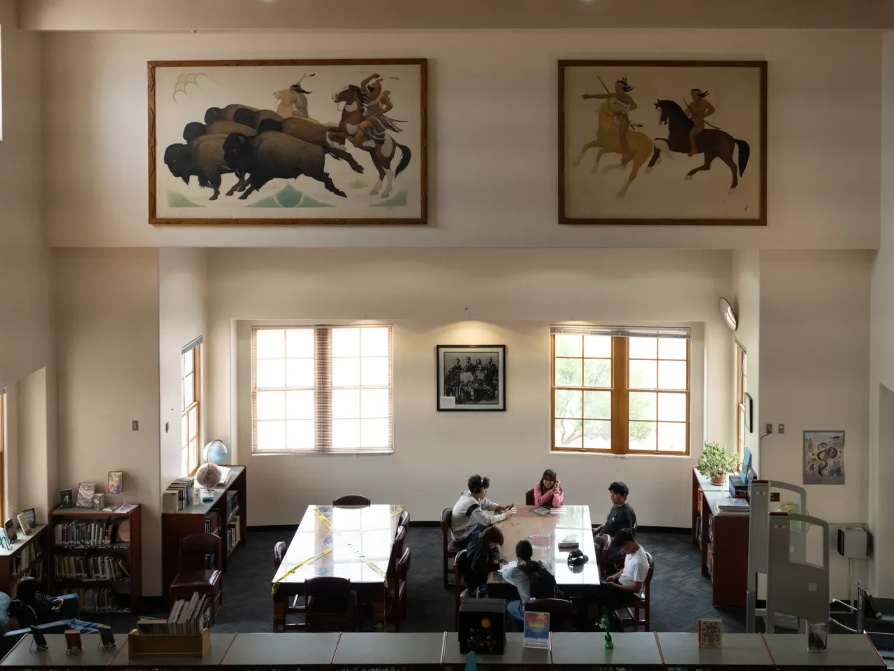Once designed to strip Native students of culture, this school now safeguards it 4 Antique murals are framed in the sunlit library at SFIS.