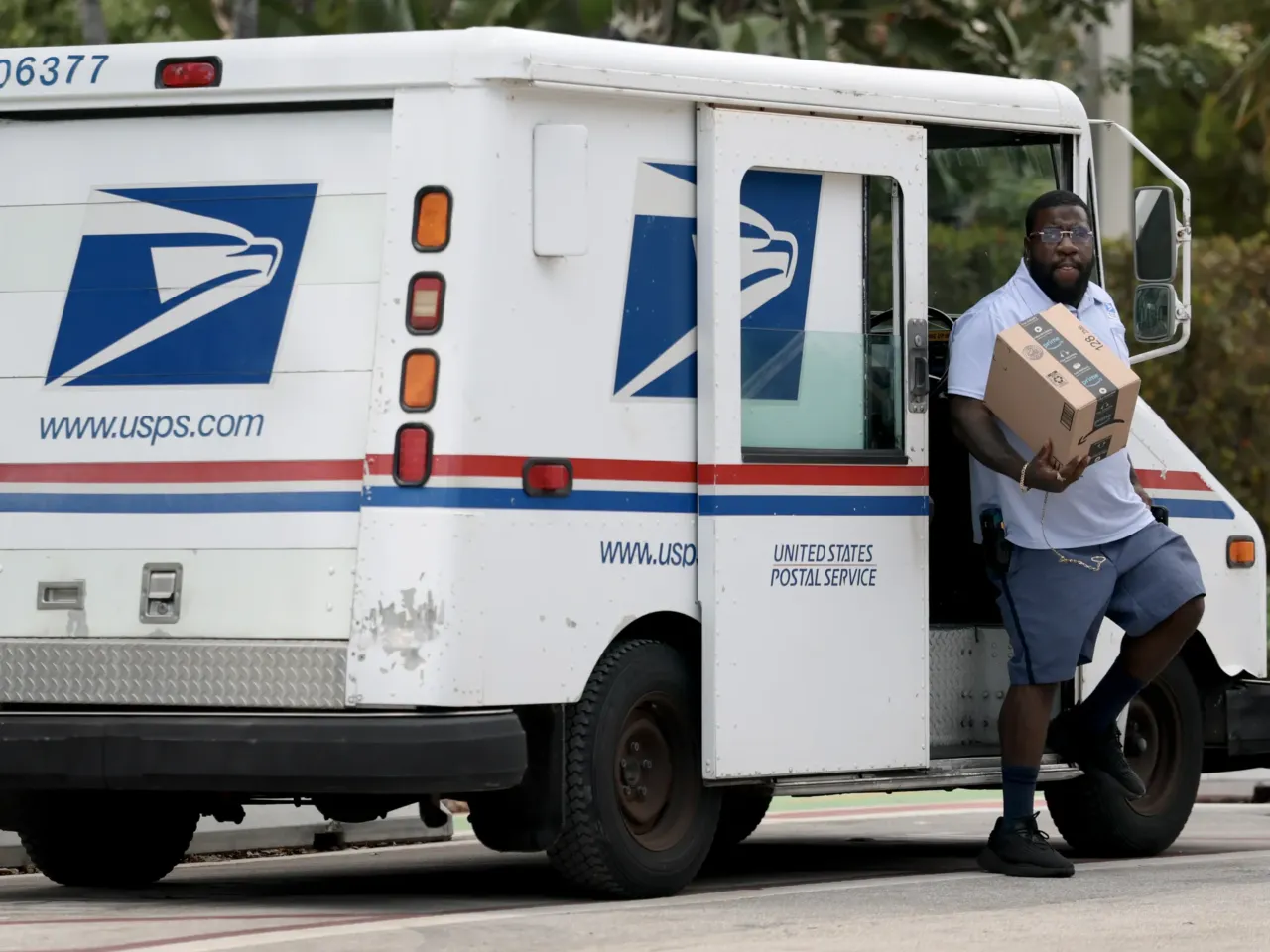 U.S. Postal Service mail carrier Marc Jacques makes a delivery in Miami in March.