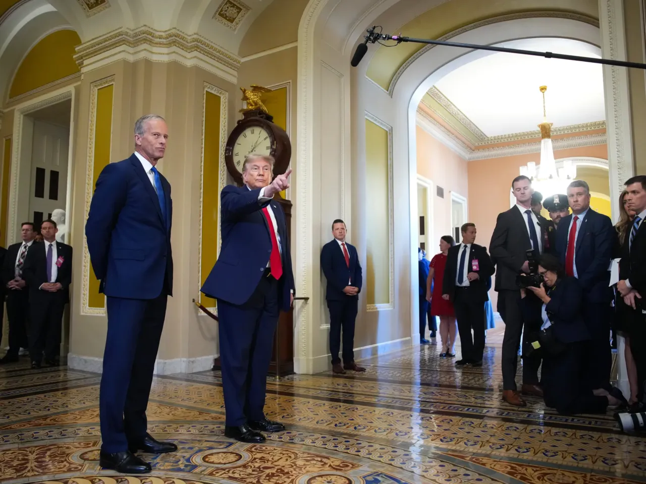 Senate Majority Leader John Thune, R-S.D., watches as President Trump speaks to the media as they arrive at the Capitol on Wednesday.