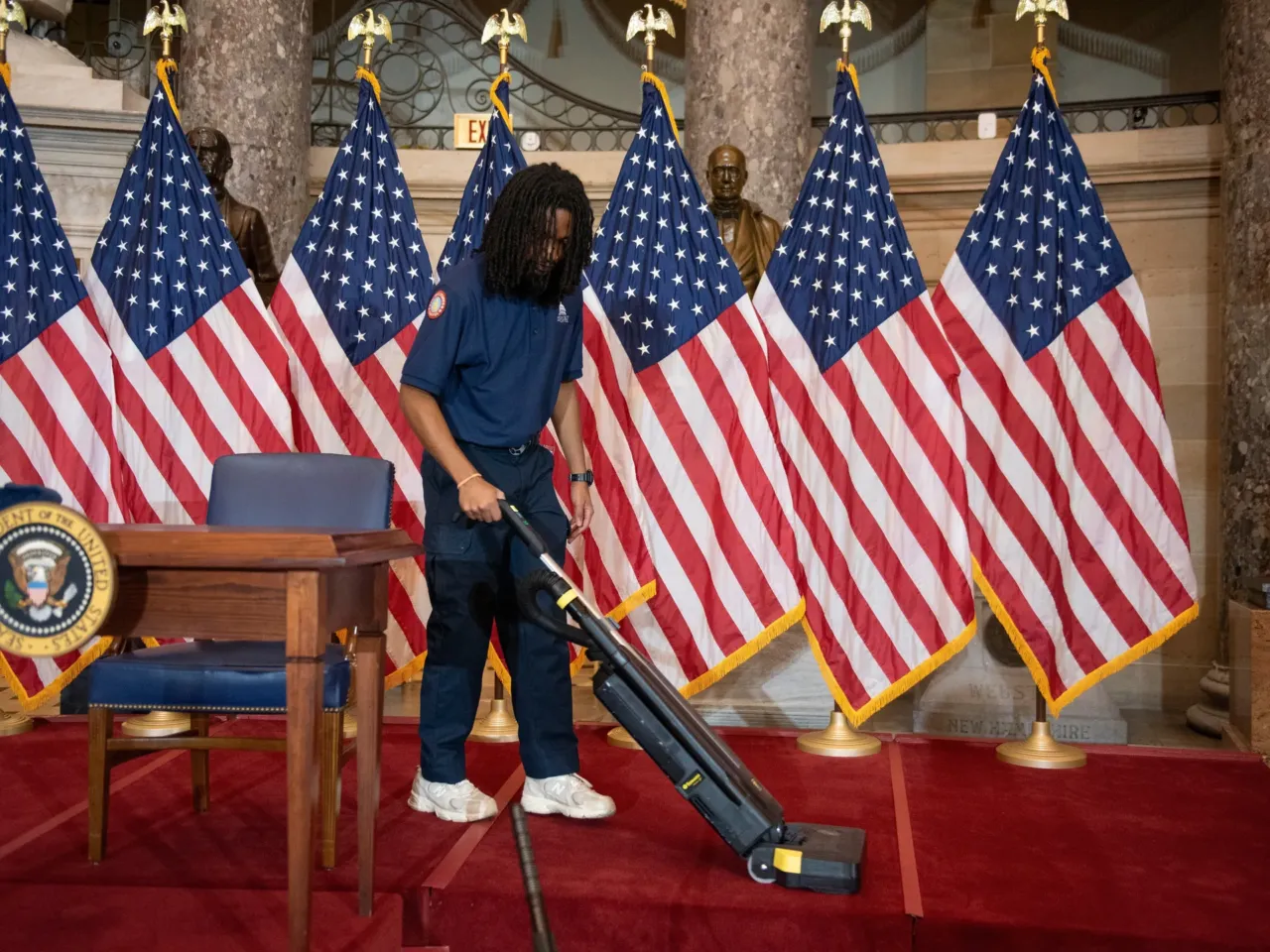 Trump cancels plans to sign housing bill, in latest sign of tension with his party 1 A worker vacuums the stage in Statuary Hall, in the Capitol, where President Trump was scheduled to sign a bipartisan housing bill on Wednesday before he abruptly cancelled the signing.