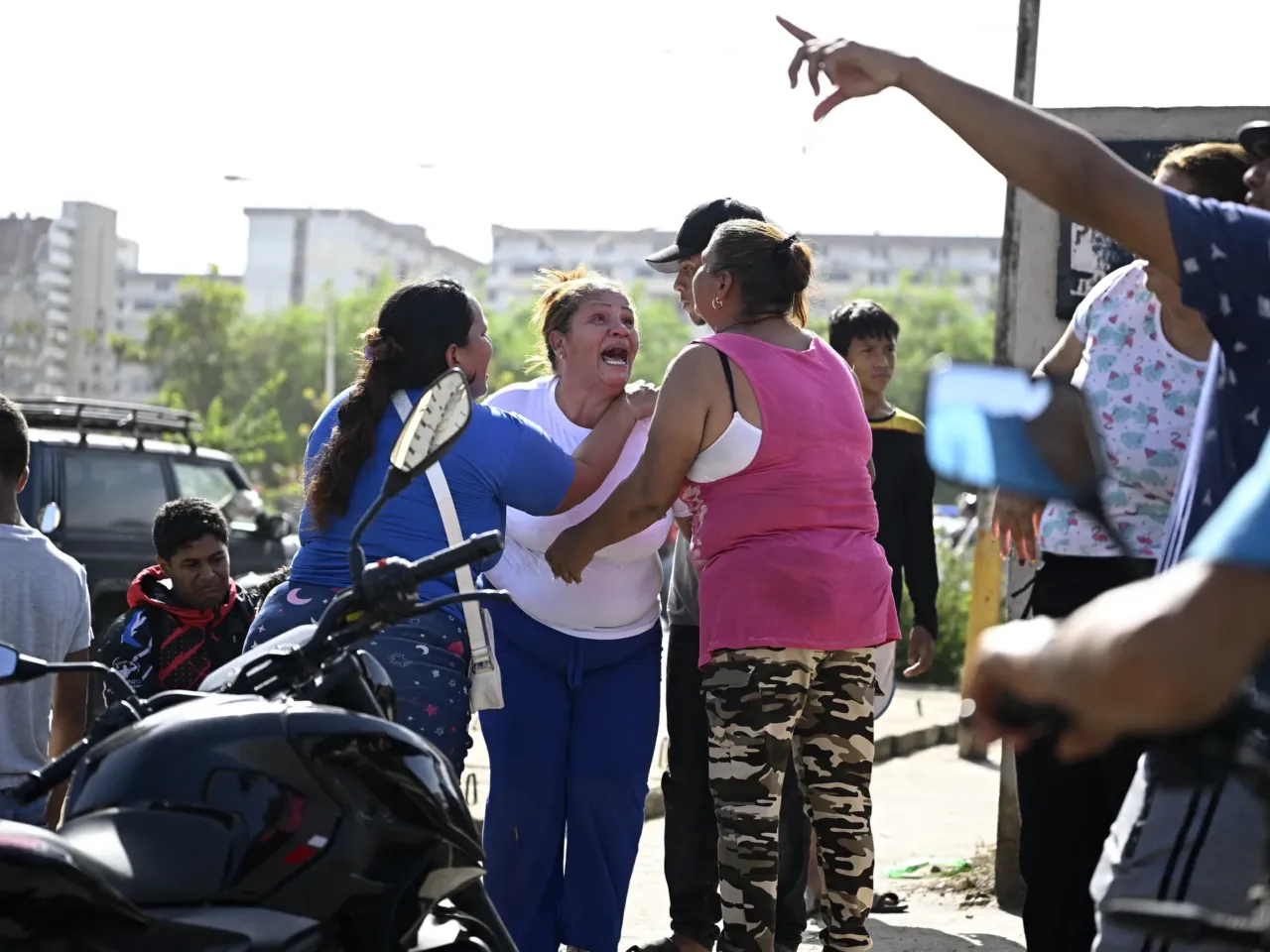 People react near a damaged apartment building following an earthquake in Catia La Mar, La Guaira state, about 30 km northwest of Caracas.