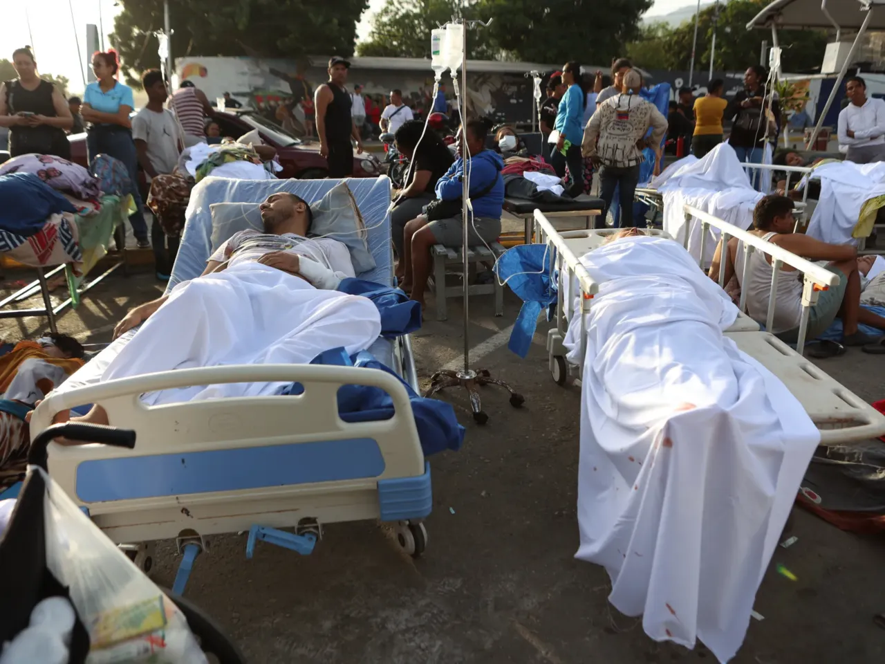 Patients lie outside a hospital evacuated after it was damaged in an earthquake in Catia La Mar, Venezuela, Thursday, June 25, 2026.