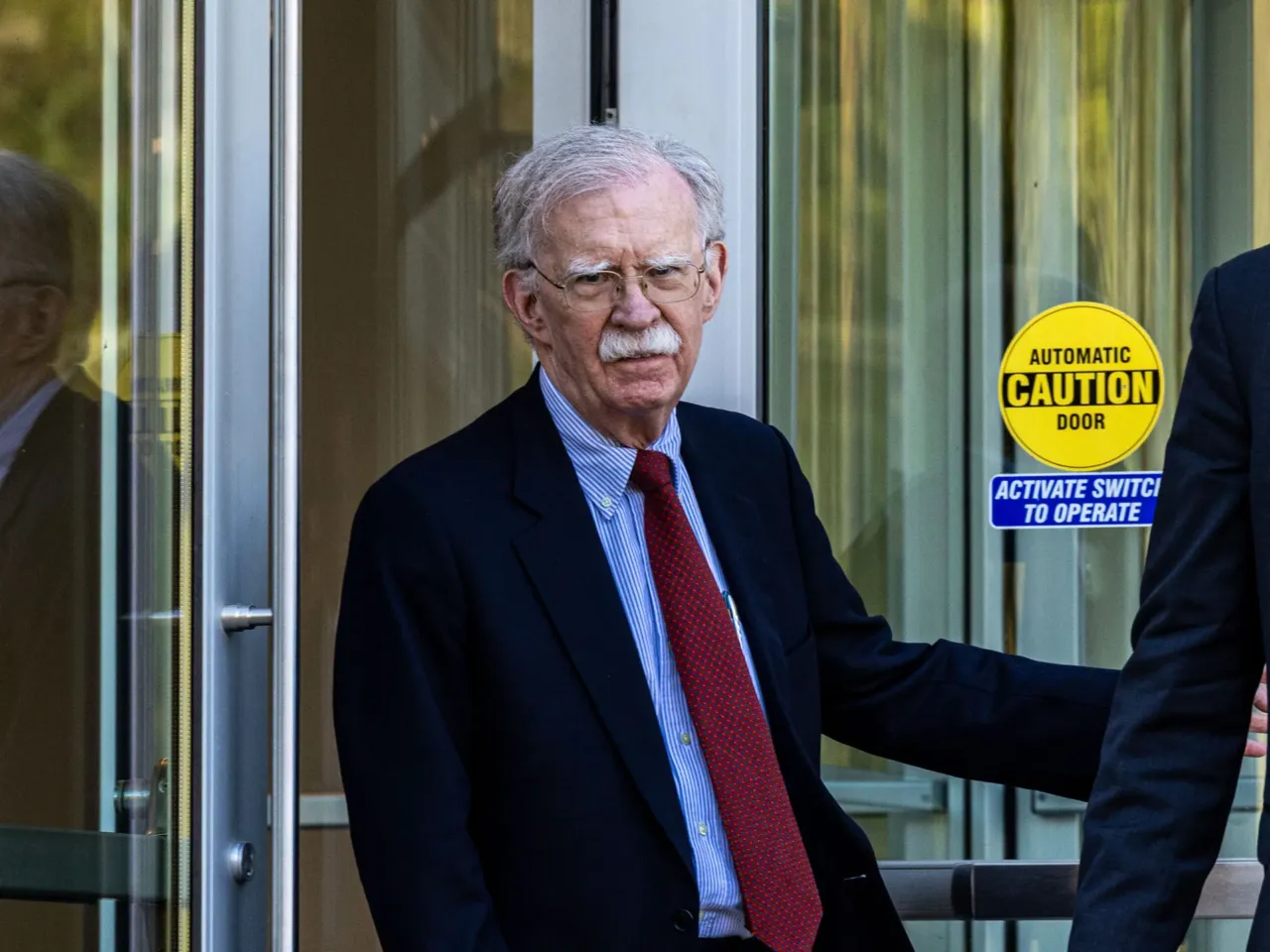 Former U.S. national security adviser John Bolton leaves federal court in October 2025 in Greenbelt, Md.