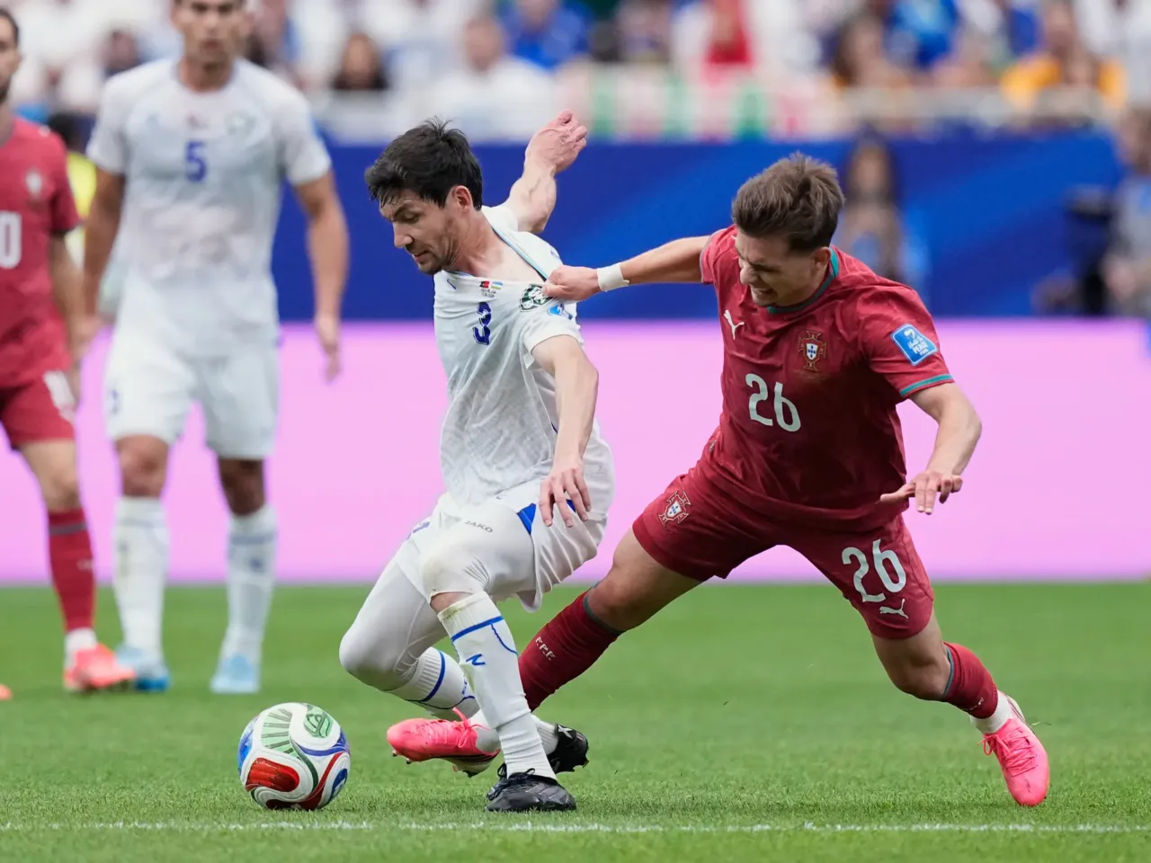 Portugal's Francisco Conceicao, right, vies for the ball with Uzbekistan's Khojiakbar Alijonov during the World Cup Group K soccer match between Portugal and Uzbekistan in Houston, June 23.