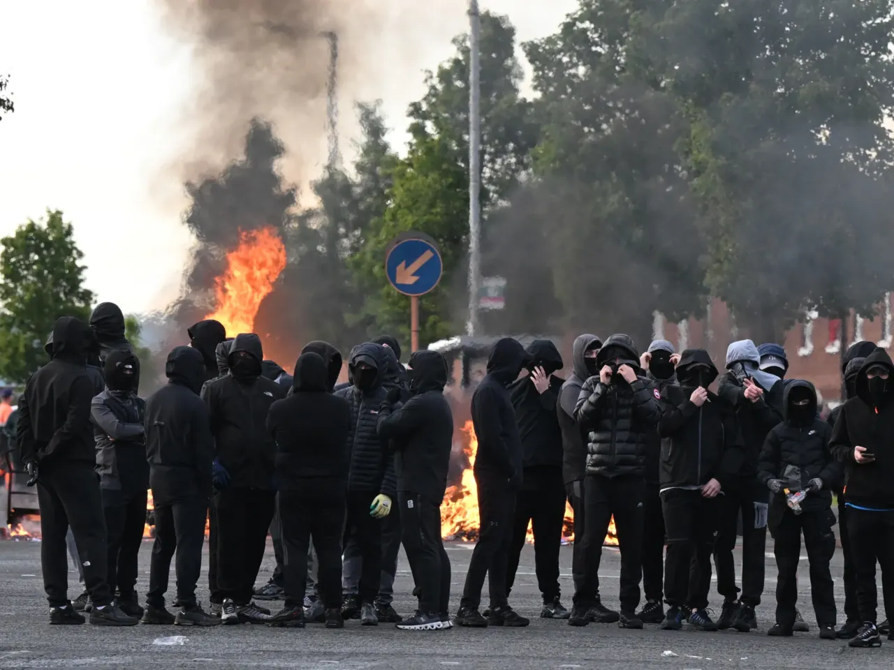 Youths gather in front of a burning barricade on Duncairn Gardens on June 9 in Belfast, Northern Ireland.