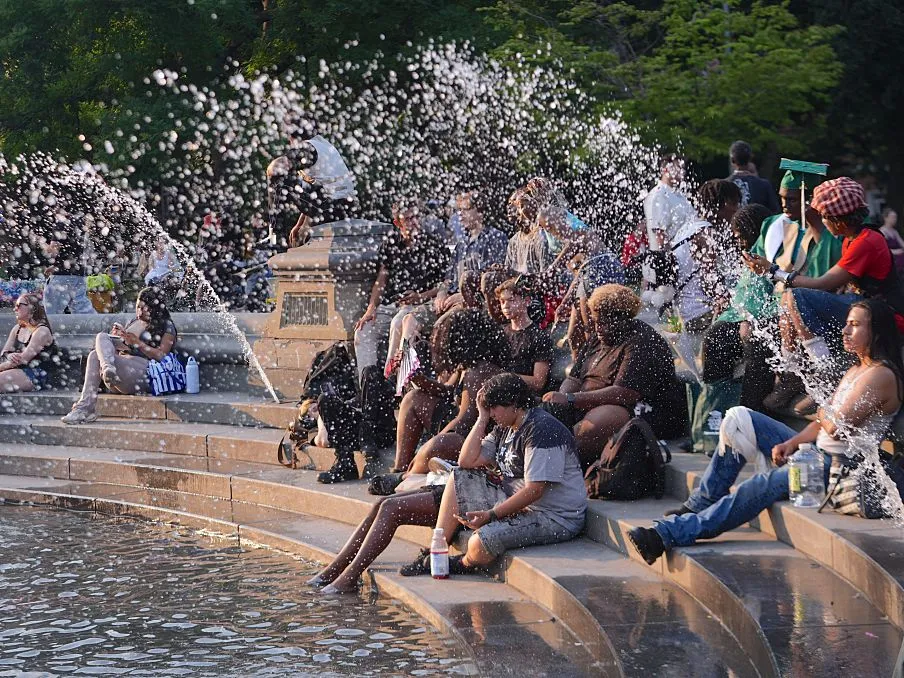 People cool off at Washington Square Park during hot weather in New York City on June 29, 2026.