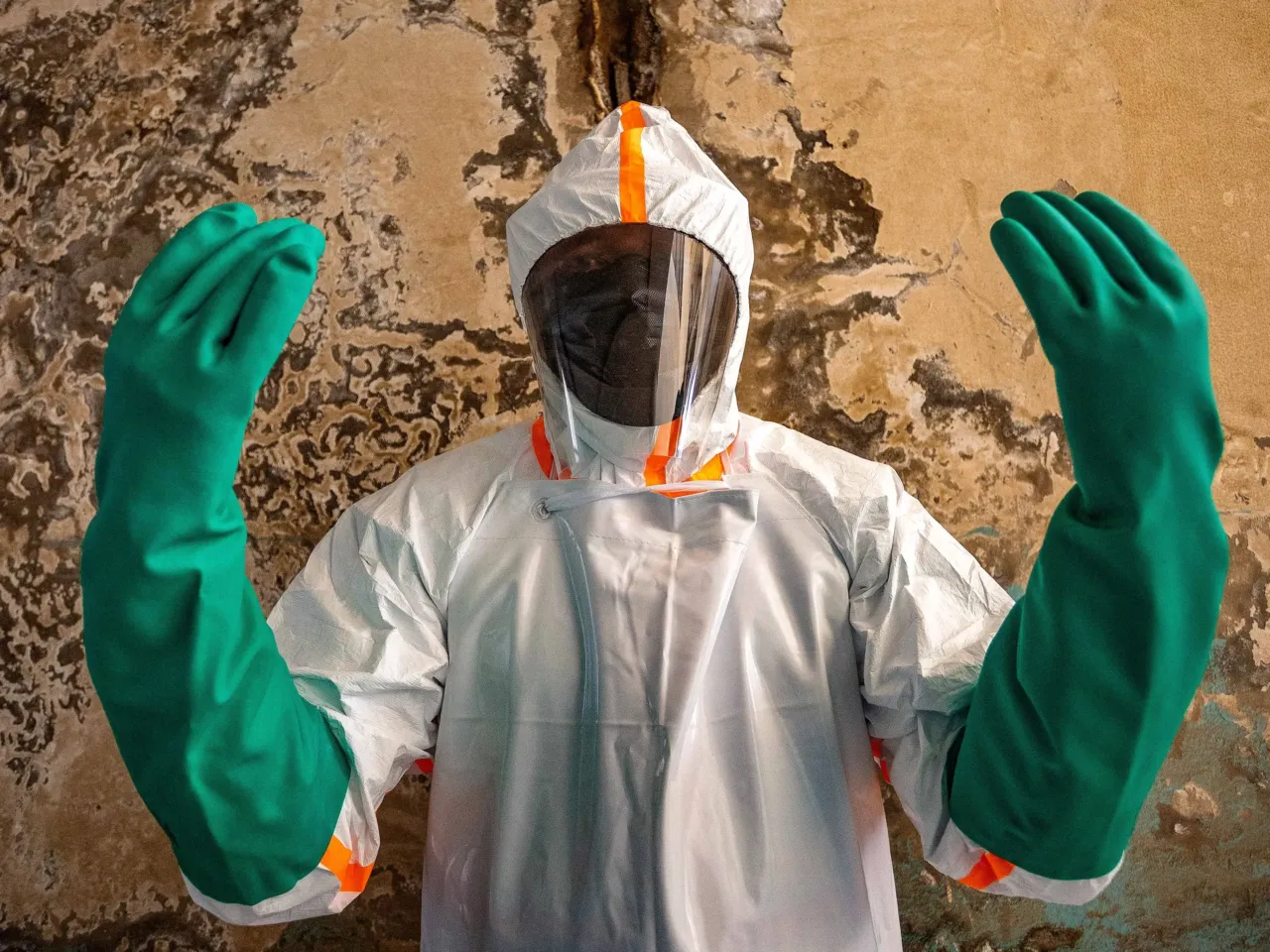 A nurse waits to be disinfected at the Clinique Universelle, in Bunia, eastern Congo, June 13, 2026. Because of attacks on healthcare workers during the Ebola crisis in DRC, some healthcare workers didn't want to give us their names.