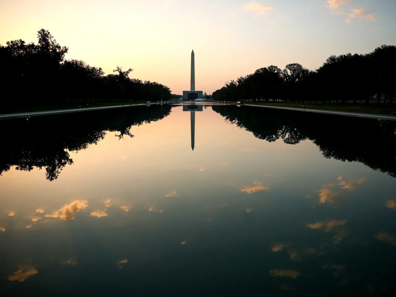 The sun begins to rise over the Lincoln Memorial Reflecting Pool on Thursday in Washington, D.C. Temperatures in the nation's capital are expected to top 100 degrees as a heat wave stretching from the Midwest to the East Coast impacts up to 90 million Americans.