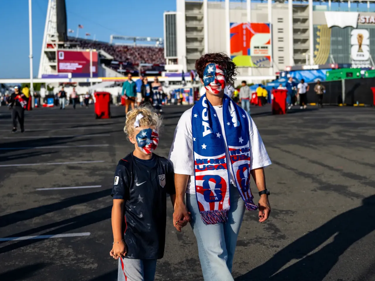 Brenda Moss and her daughter, Rome, 8, stand in front of the San Francisco Bay Area Stadium.