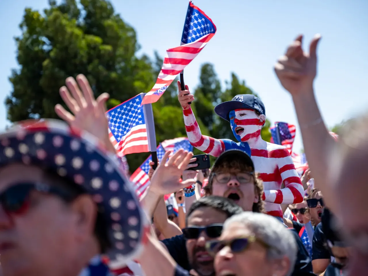 U.S. national men's team soccer fans cheer before marching to the San Francisco Bay Area stadium for the game.
