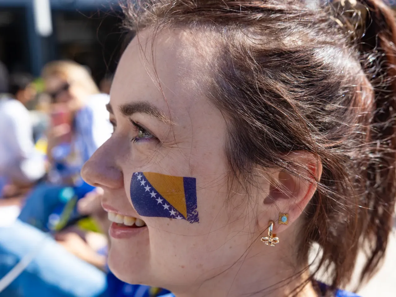 Melita Advic wears a Bosnia-Herzegovina face tattoo on her cheek while awaiting the start of the game at a watch party at Thrive City in San Francisco.