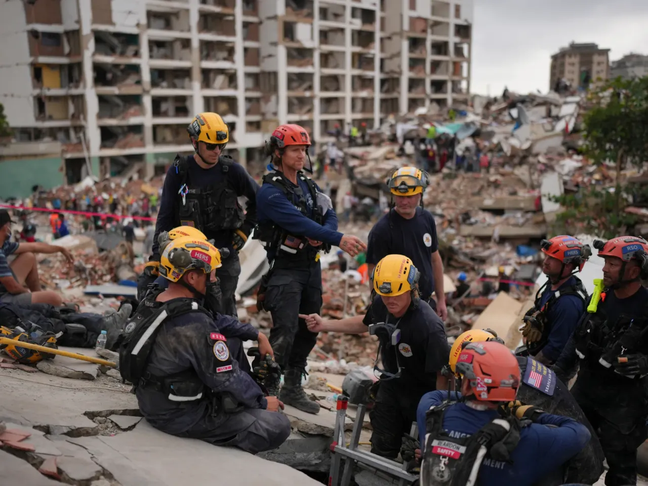'We can still pull out live victims': LA rescuers join Venezuela quake rescue efforts 1 Member of the Los Angeles County Fire Department stand on rubble of a collapsed building in La Guaira, Venezuela, Tuesday.