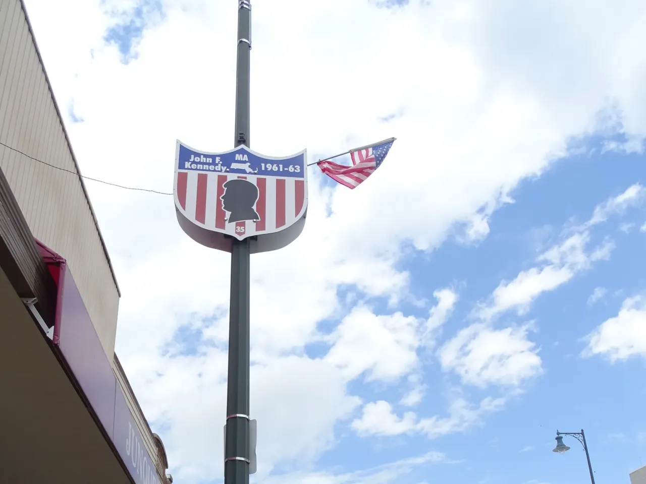 Donna Rogers shows off one of Cuba City's presidential lampposts.