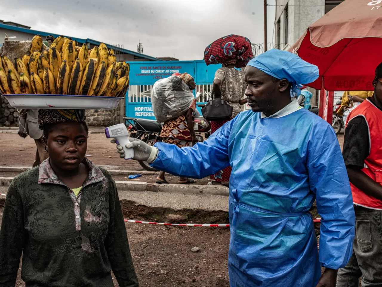 A health worker takes a woman's temperature as part of Ebola screening efforts in Goma, Democratic Republic of Congo. As part of the effort to quash the outbreak, the first patients have been enrolled in a clinical trial to test two drugs against the Bundibugyo strain of the virus that is spreading there. In addition, researchers plan to study whether another drug could protect people exposed to the virus.