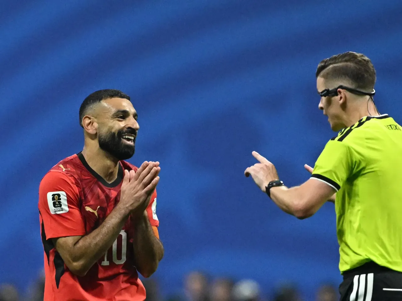 French referee François Letexier speaks with Egypt forward Mohamed Salah during the World Cup Round of 16 match between Argentina and Egypt in Atlanta.