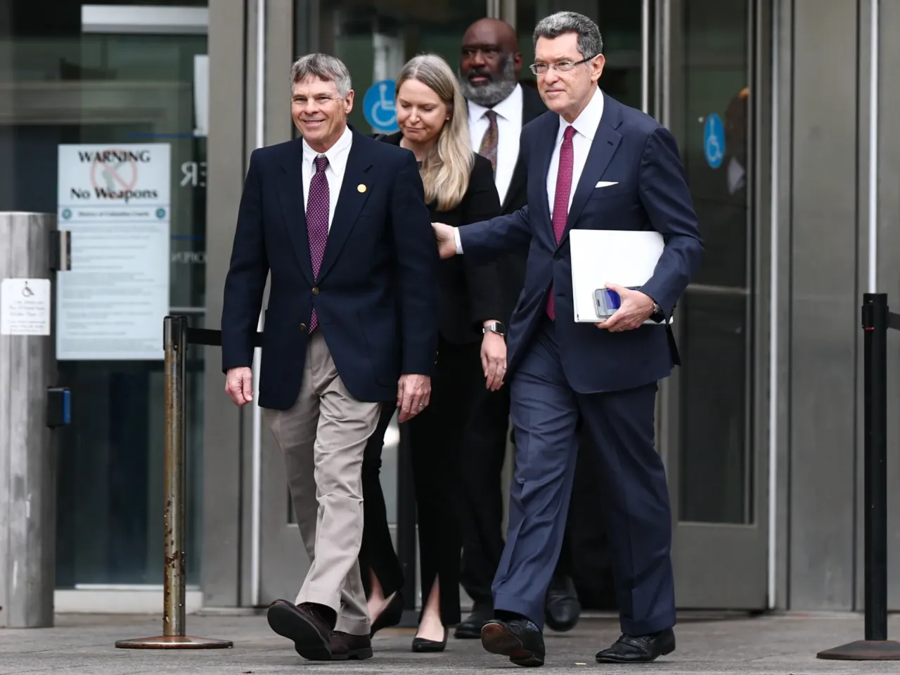 Former U.S. Olympian David Hearn (left) walks with his attorney Norman Eisen to speak to reporters and protesters gathered after his arraignment at the Superior Court of the District of Columbia in Washington, D.C. on Thursday.