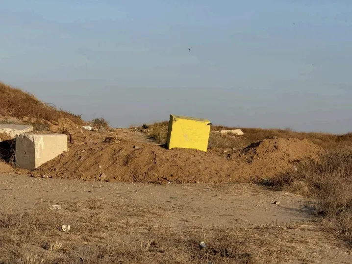 9 months into a ceasefire, Israel now controls nearly 70% of Gaza 3 A yellow concrete block sits on a dirt berm marking an encroaching military boundary across Salah al-Din Street, Gaza's main road, as Israeli forces continue to advance their positions deeper into the territory.