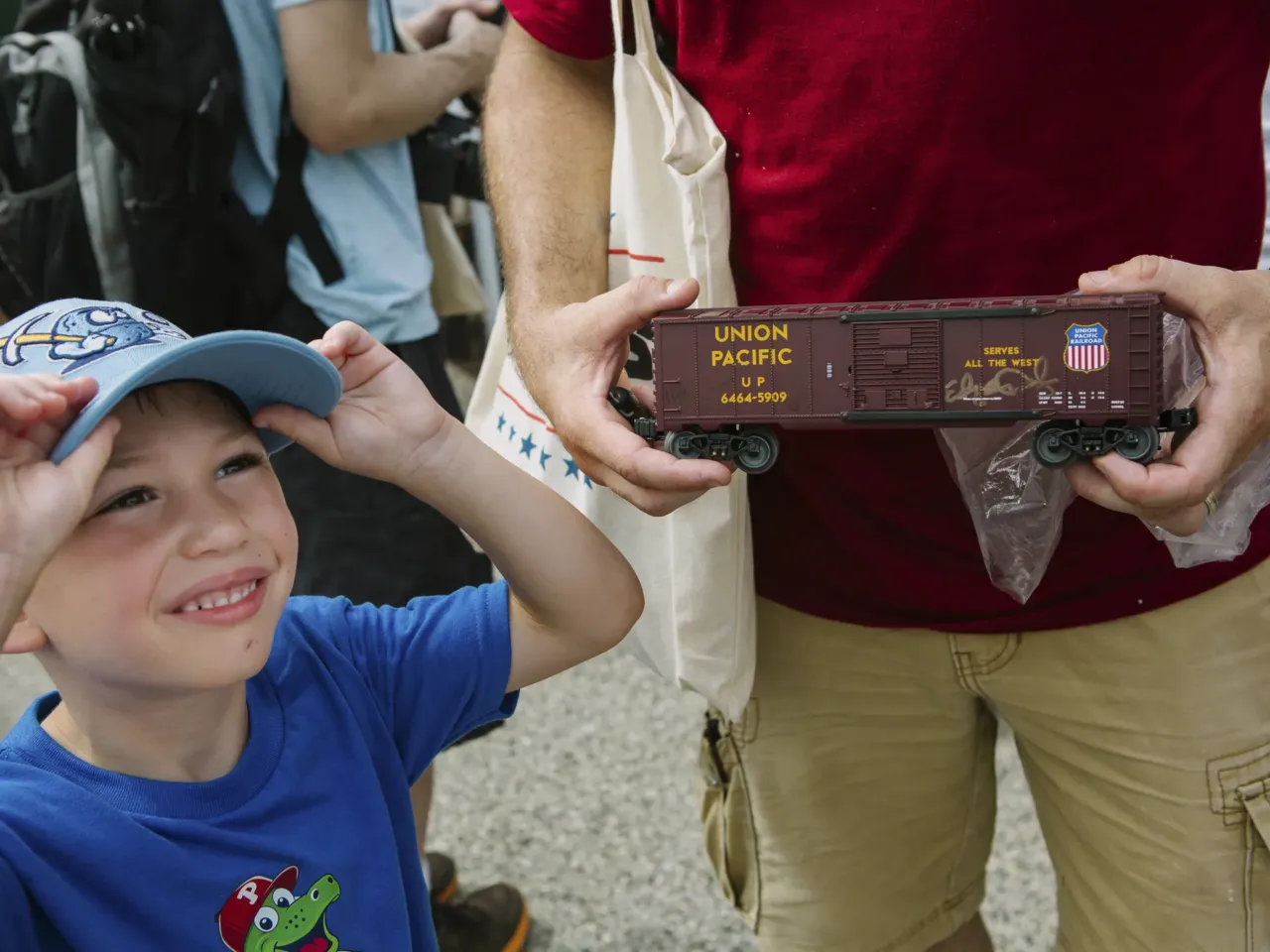 The biggest steam locomotive is whistle-stopping across the U.S. 7 Joe Stefankiewicz, 37, of Aston, Pennsylvania, holds a signed model train car for his son, Joey, 5, in front of Union Pacific's Big Boy No. 4014, the world's largest operating steam engine locomotive, during a stop in Philadelphia.
