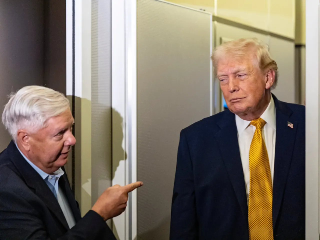 Sen. Lindsey Graham, R-S.C. (left) gestures as President Trump speaks with reporters while in flight on Air Force One as they were returning to Joint Base Andrews, Md., on Jan. 4.