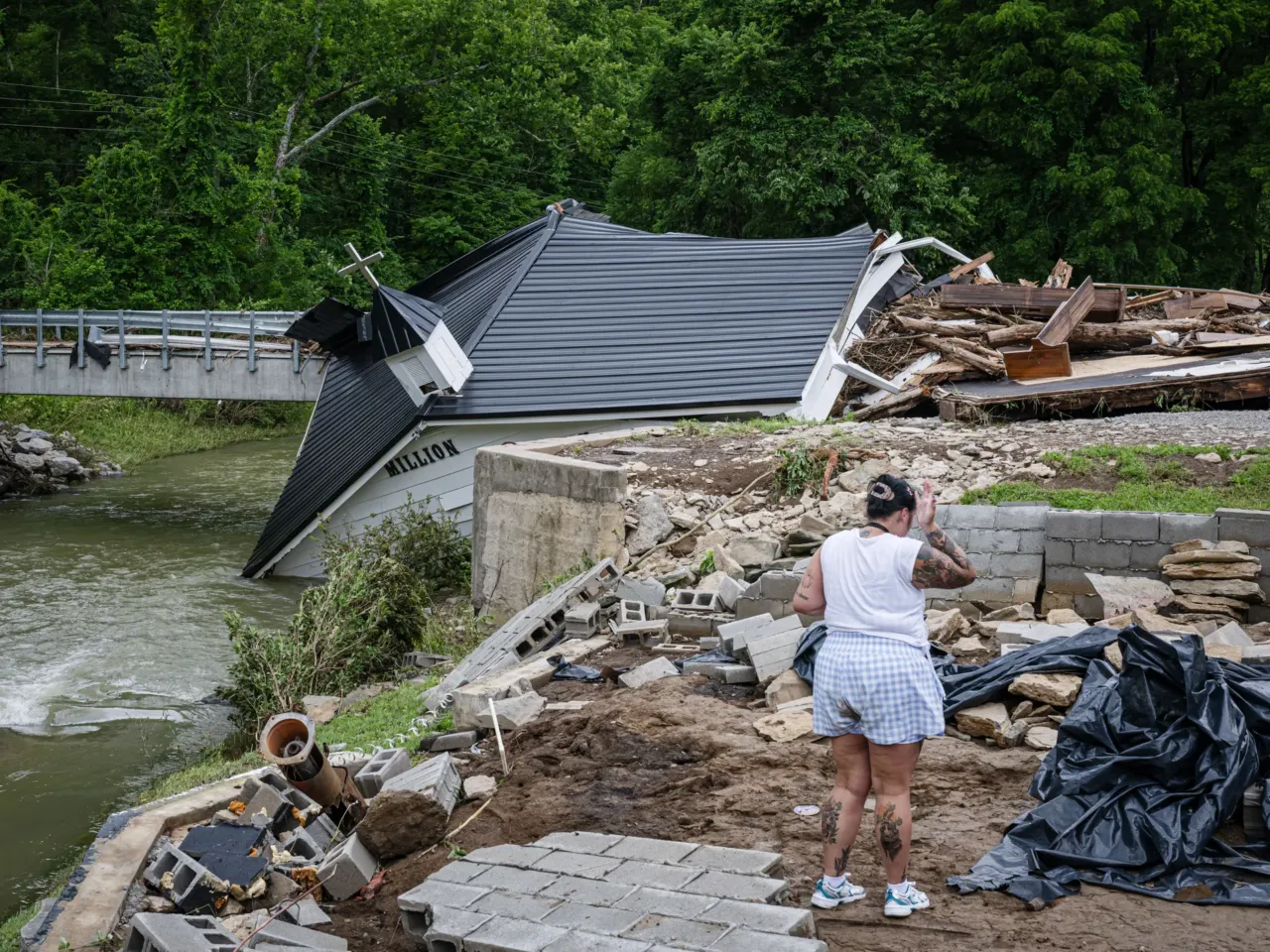 A person looks on from the wrecked foundation of Million Bible Church on June 28 in Richmond, Ky. A day earlier, Kentucky Gov. Andy Beshear declared a state of emergency in Kentucky, which has seen severe weather for weeks.