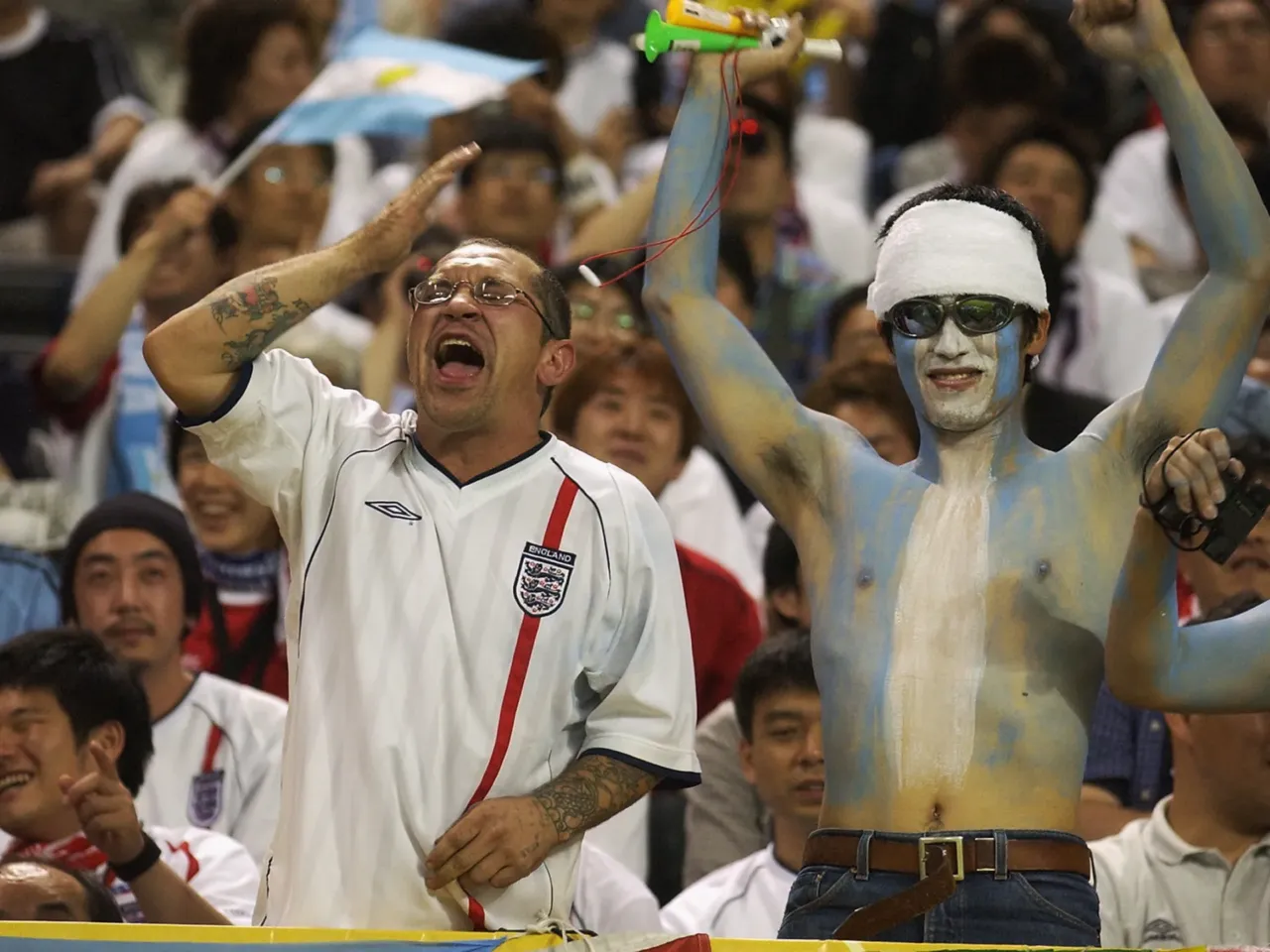 England and Argentina fans sit side by side during the FIFA World Cup match in Sapporo, Japan, on June 7, 2002. England won 1-0. The old rivals meet again this year in a World Cup semifinal showdown.