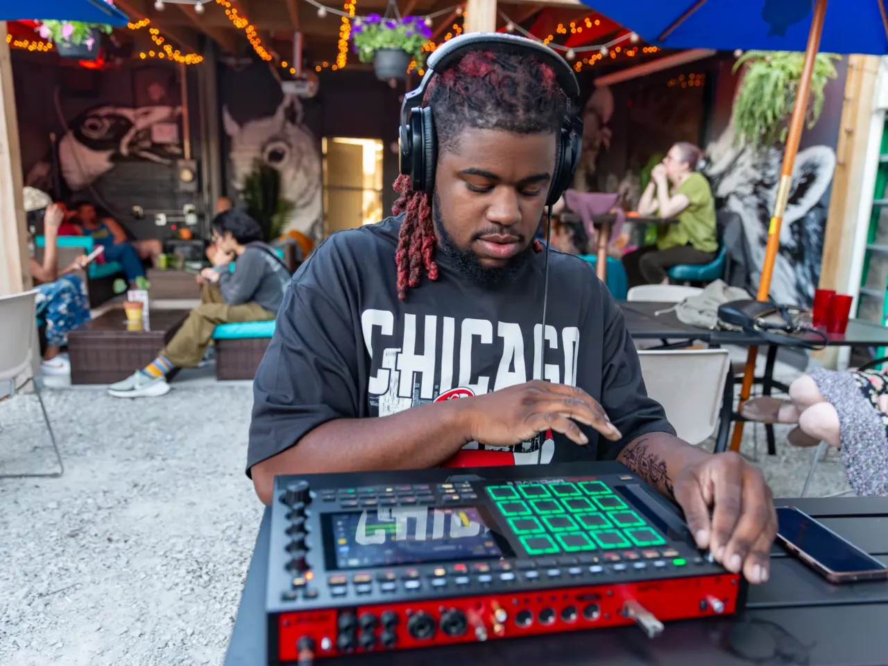 Flip a Beat Club Chicago (FABC) chapter participant and artist Ace makes beats using an MPC (or "beat machine") at the bar and art space Nighthawk in Chicago on May 15. According to FABC Chicago founder Cory Morrison, participants make beats using samples provided by the club. The event is livestreamed.