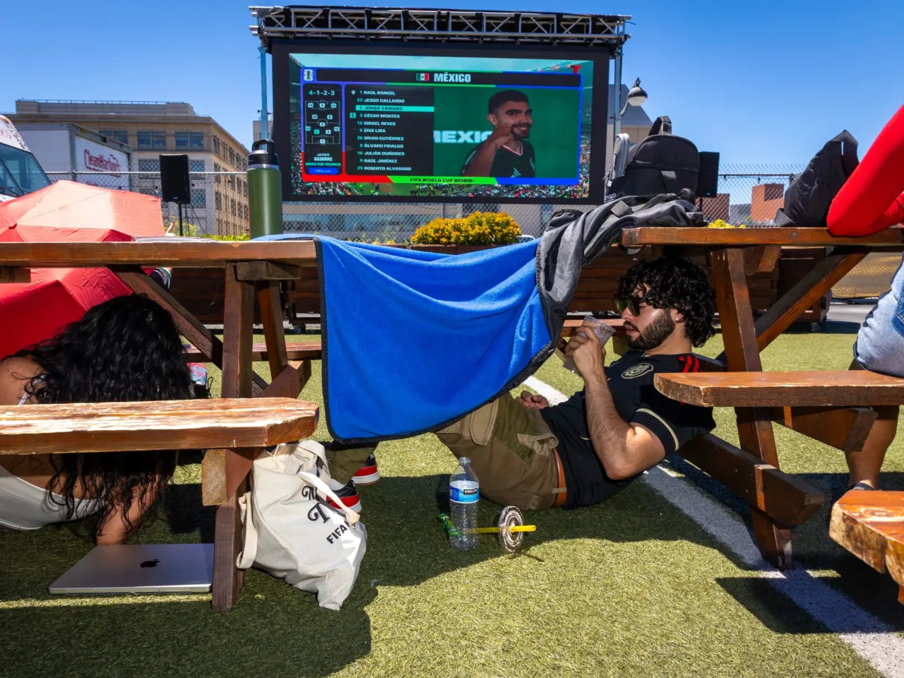 Photos: When the World Cup came to town 4 People find shade under tables, benches and blankets at a Mexico vs. South Africa World Cup watch party at SPARK Social SF in San Francisco on Thursday, June 11.