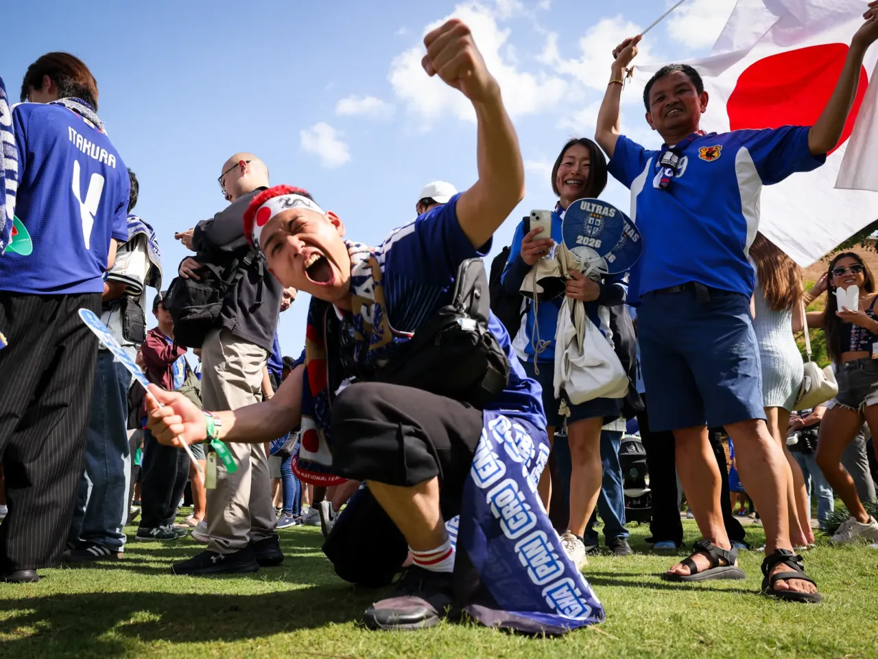 Photos: When the World Cup came to town 7 Toshiki Hayashi (center) and other fans cheer for Japan at a Paint It Blue event before the World Cup game Wednesday, June 24, at Harwood Park in Dallas.