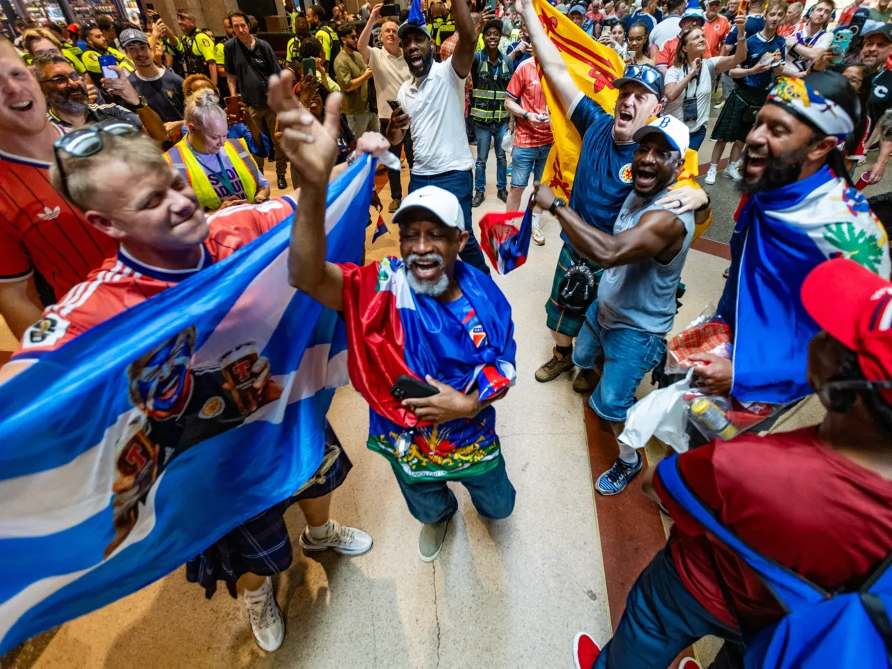 Photos: When the World Cup came to town 12 Scottish and Haitian fans dance and chant together inside Boston's South Station while waiting to board MBTA trains to the World Cup match between Scotland and Haiti in Foxborough, Mass., on Saturday, June 13.