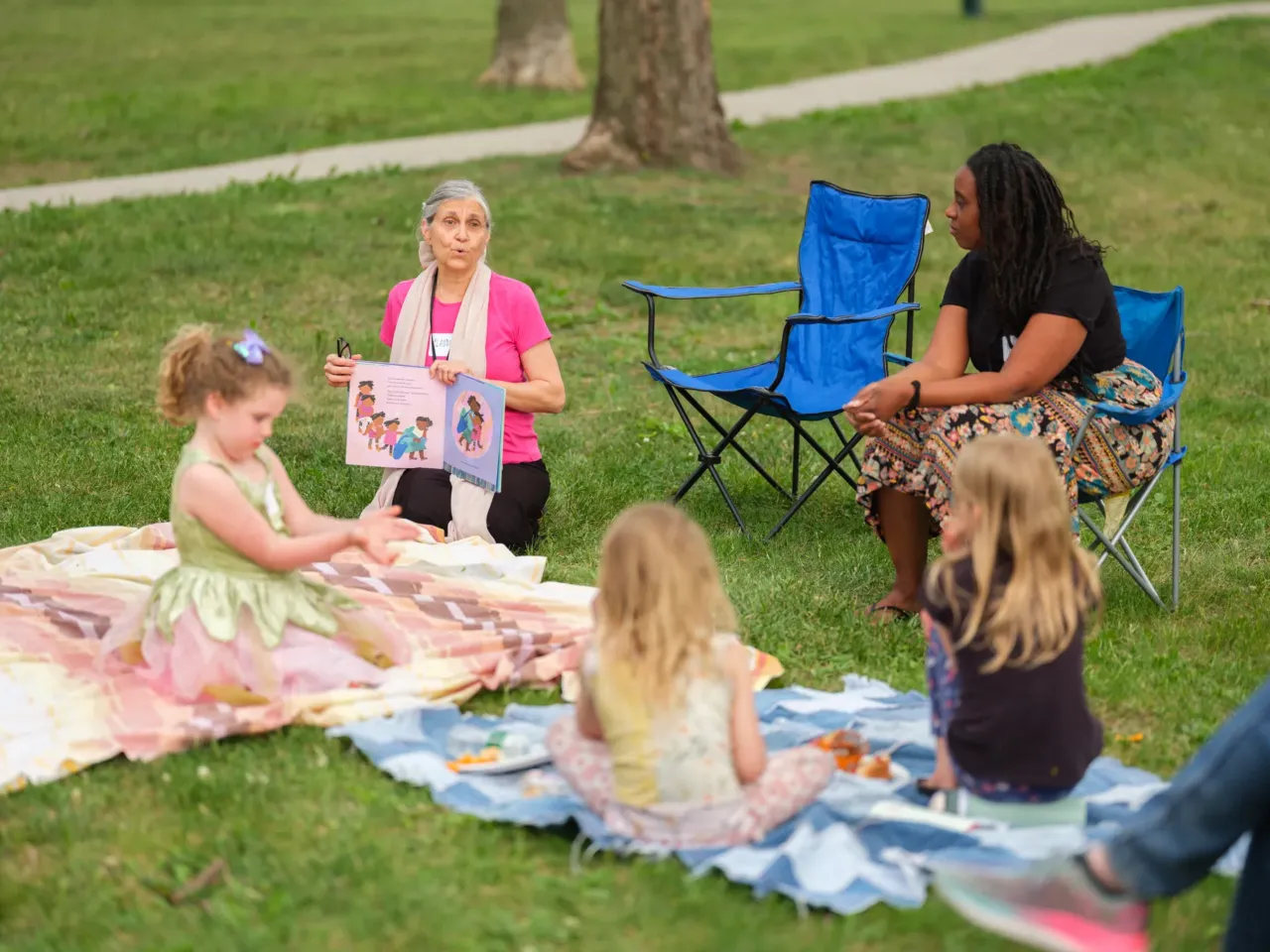 Storyteller Claudia Rains reads to families during Prime Time Family Reading at Henry Park in Lincoln, Neb., on May 14, 2026. Prime Time is a program that helps children hone their reading and critical thinking skills and is supported by Nebraska's endowment fund.
