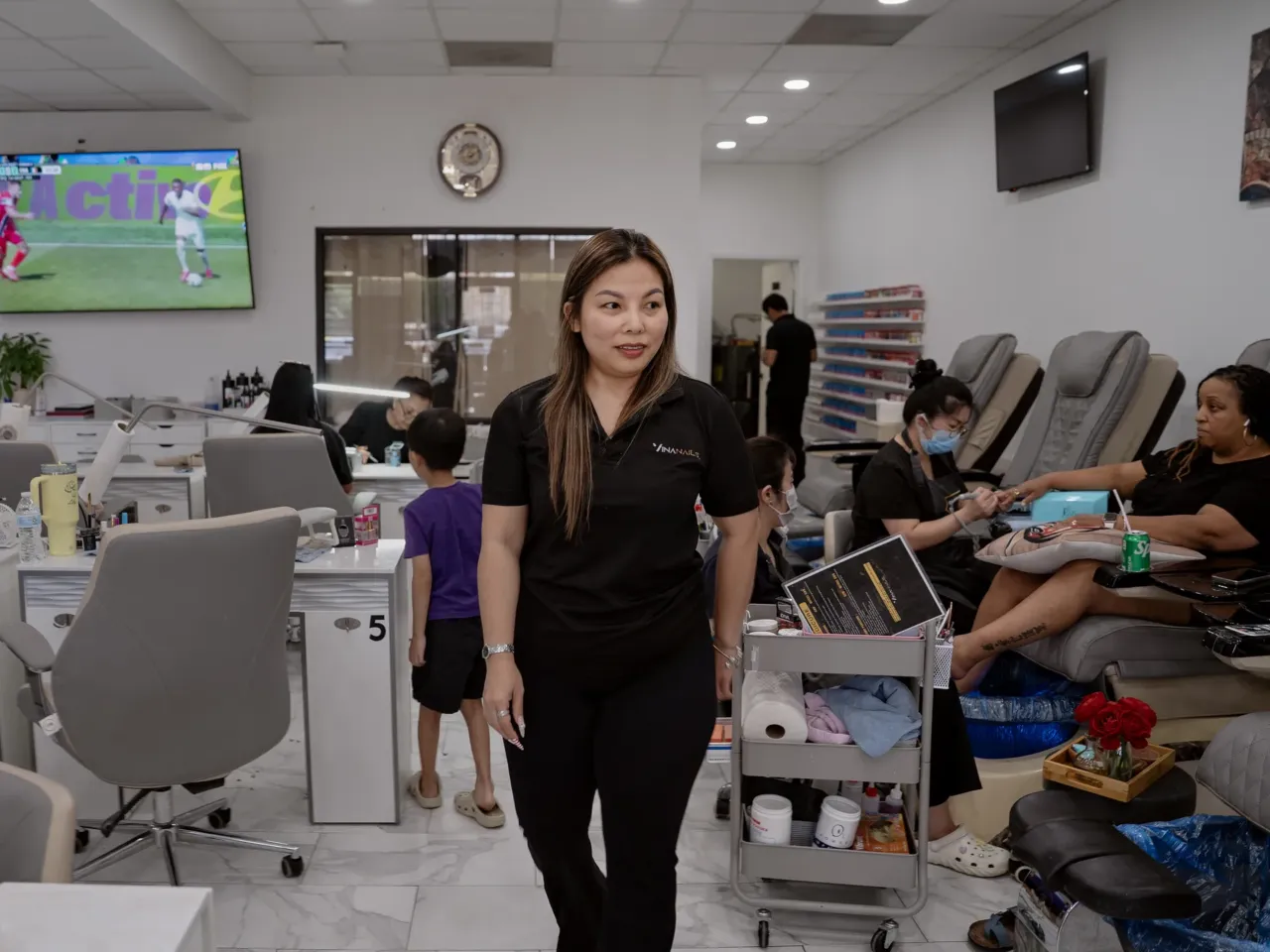 Reporter's Notebook: Finding World Cup joy in speaking to women who love soccer 1 Vy Nguyen walks through while painting nails at her salon, Vina Nails, in Houston, Texas, on June 26, 2026.