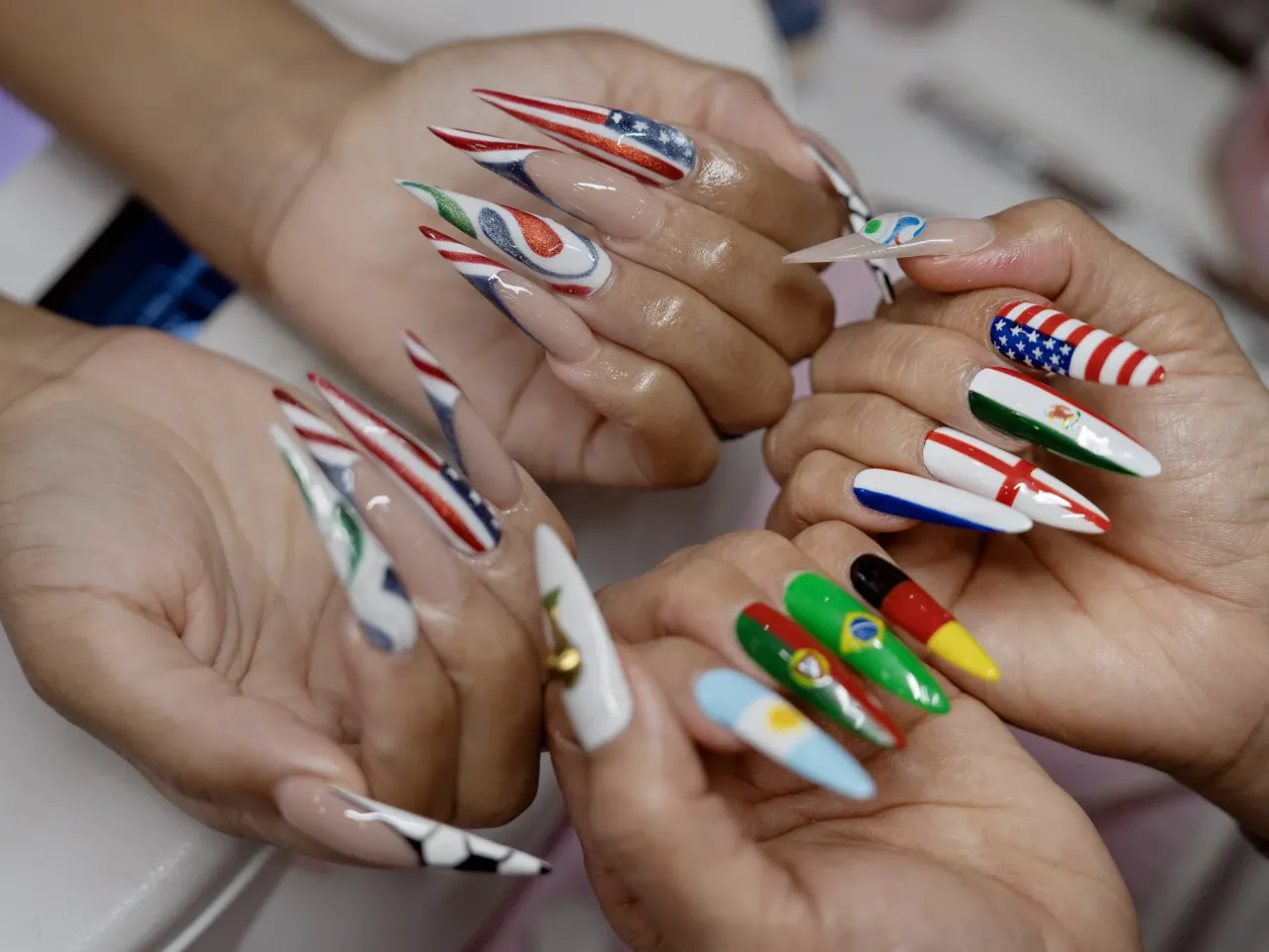 CeeCee Barrett, left, and Vina Nails owner Vy Nguyen, right, showcase their FIFA World Cup-inspired art at her salon in Houston, Texas, on June 26, 2026.