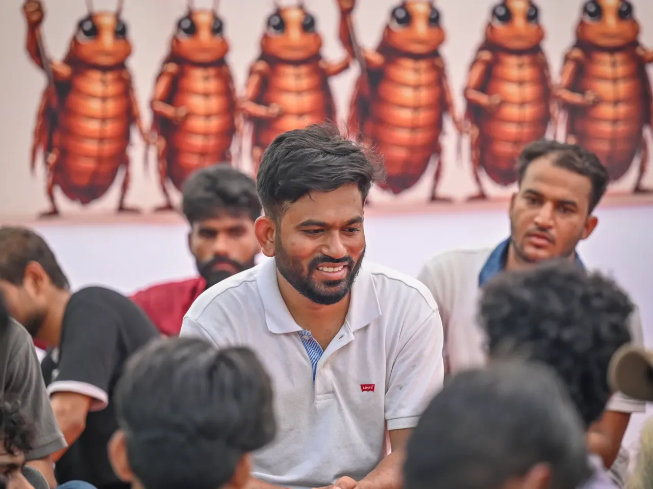 India's Gen Z 'Cockroach People's Party' started as satire but is serious about change 3 Cockroach Janta Party founder Abhijeet Dipke sits with supporters at Jantar Mantar, demanding the resignation of the education minister over an exam leak controversy, and urging others to join the demonstration, on June 23, in New Delhi, India.