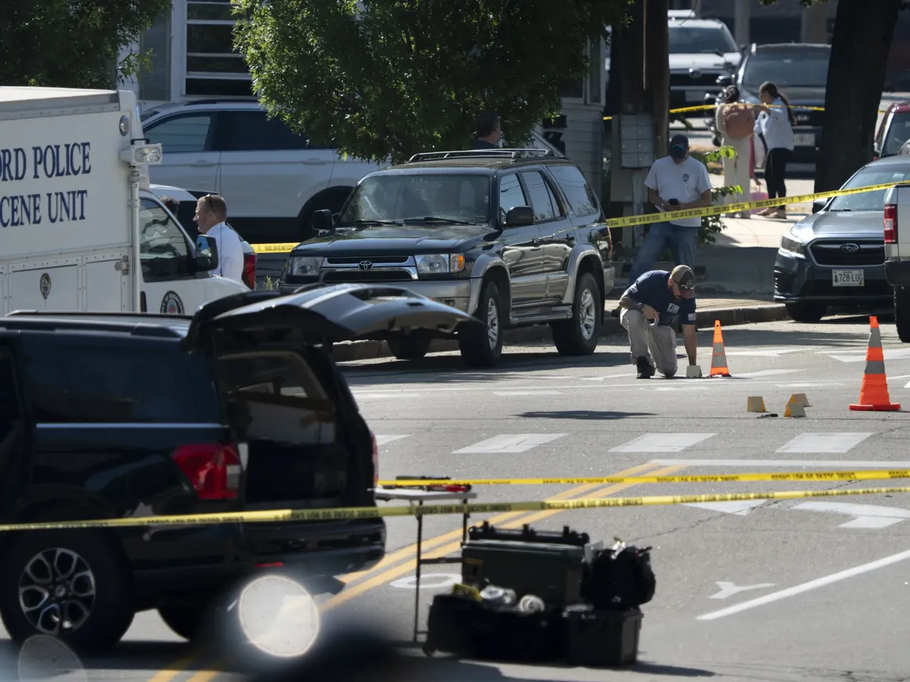 An FBI official places an evidence card in Biddeford where a man was killed in a shooting involving U.S. Immigration and Customs Enforcement agents on July 13, 2026.