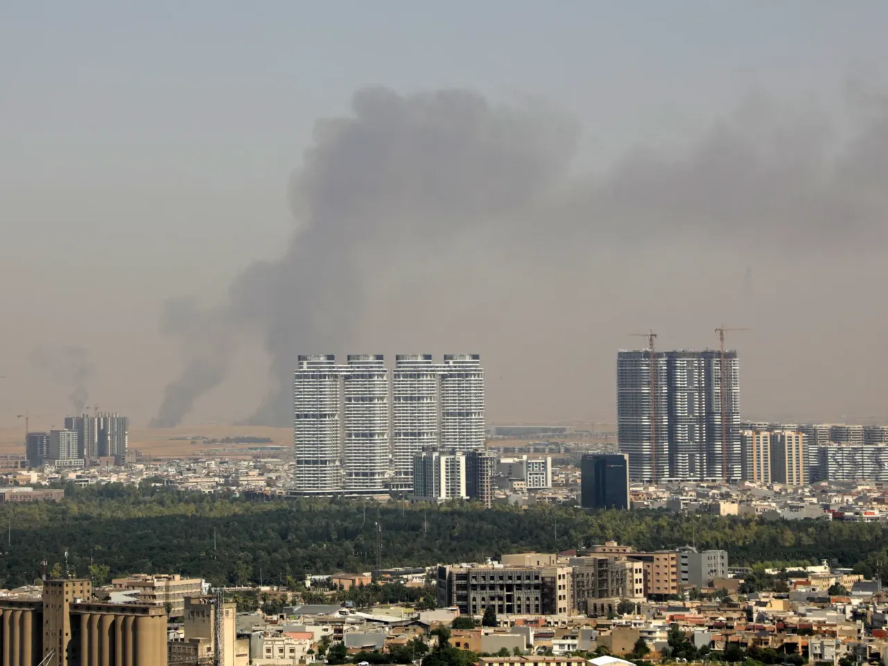 Smoke rises after explosions were heard and air defenses activated near the airport in Irbil, in the Kurdistan region of northern Iraq, on Friday. Several blasts sounded near the Irbil airport, which hosts U.S.-led coalition troops, an AFP journalist said.