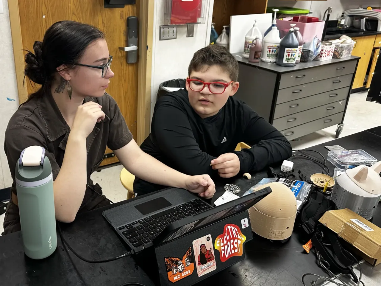 Meet the robots programmed by kids to speak their Indigenous languages 1 Boyer and Hoy work on some last-minute adjustments to his AI-powered SkoBot before presenting at his school's end-of-year showcase, called the STEAM Museum.