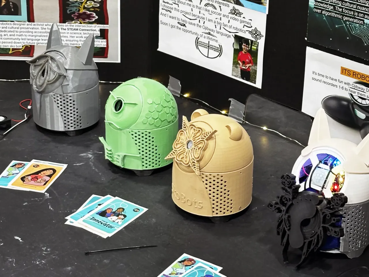 Meet the robots programmed by kids to speak their Indigenous languages 2 Hoy's Sabe, or Bigfoot, SkoBot on display (right), alongside three other SkoBots that Boyer brought with her to show off at the STEAM Museum. Each represents a specific animal: a wolf, turtle and bear. Hoy's SkoBot is 3D printed in light gray, and its face is adorned with a footprint surrounded by floral designs.